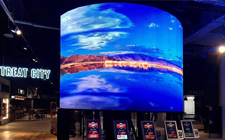High-quality convex LED screens promoting movie releases in a cinema.