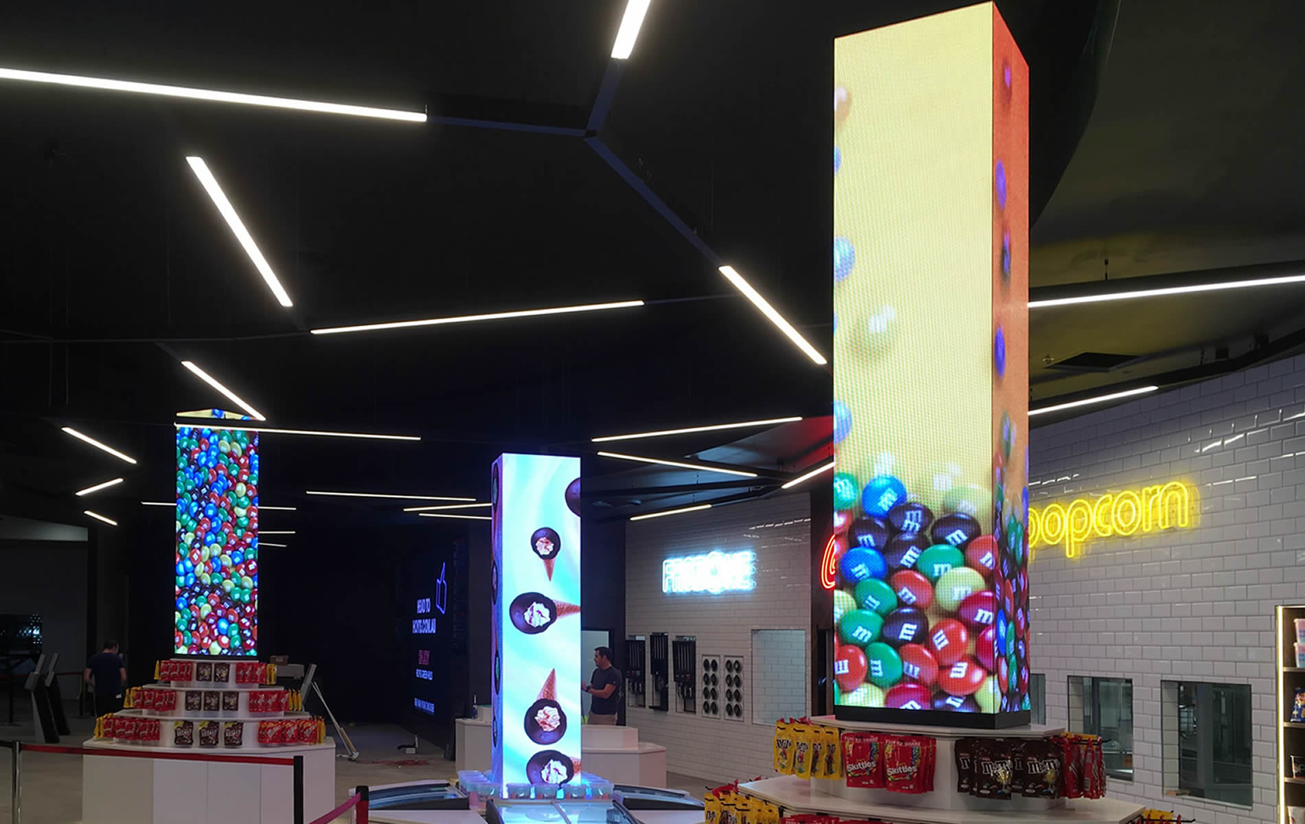 Square LED columns creating multi-sided visual effects.